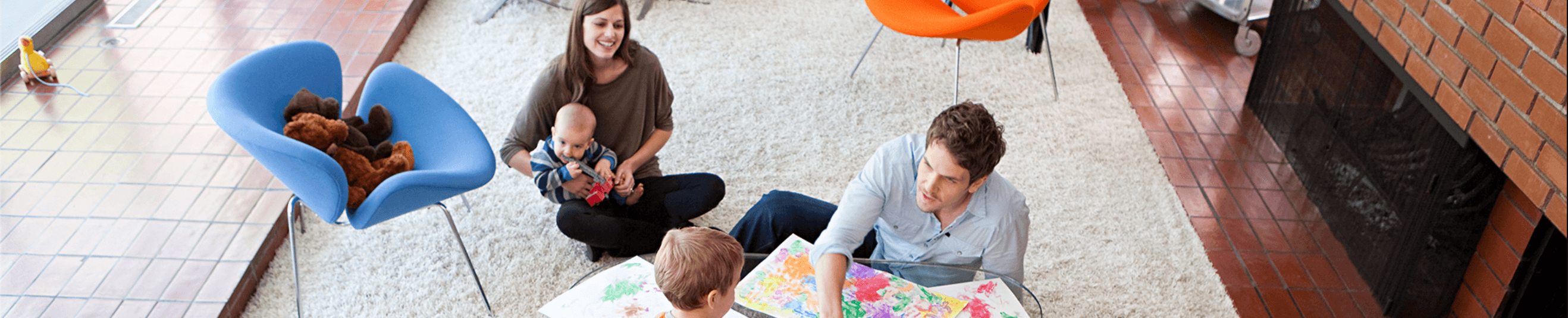 Family in a living room with children drawing
